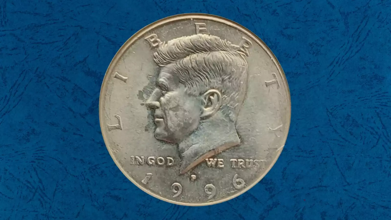 1996 Kennedy half dollar grease-filled die error with weakened or missing inscriptions due to lubricant-packed die